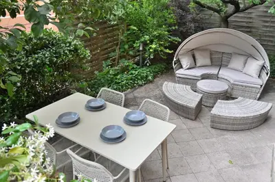 a patio with a table and chairs and a couch at Appiano Garden Apartment in Rome