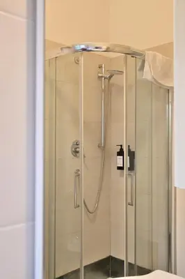 a shower with a glass door in a bathroom at Appiano Garden Apartment in Rome