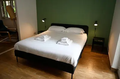 a bedroom with a bed with towels on it at Appiano Garden Apartment in Rome