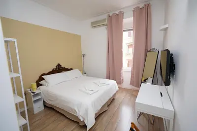 a bedroom with a bed and a television in it at Appartamento Vaticano Metro A in Rome