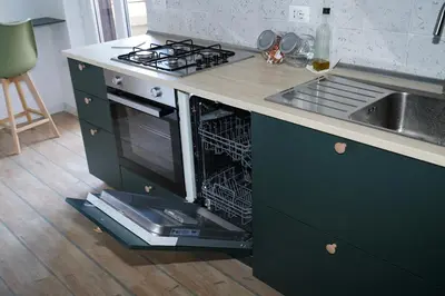 a kitchen with an open dishwasher next to a sink at Appartamento Vaticano Metro A in Rome