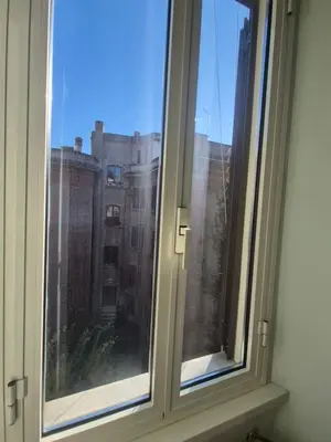 a window with a view of a building at La casa di Giulia in Rome