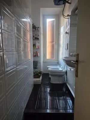 a bathroom with a toilet and a sink and a window at La casa di Giulia in Rome