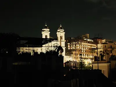 a large white building with two towers at night at Exclusive Flat Piazza di Spagna in Rome