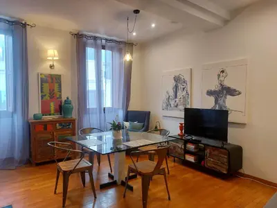 a living room with a glass table and a television at Exclusive Flat Piazza di Spagna in Rome