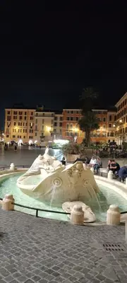 a statue in the middle of a city at night at Exclusive Flat Piazza di Spagna in Rome
