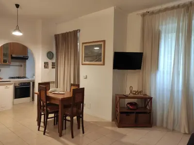 a kitchen and dining room with a table and chairs at Fabio's Home Gemelli in Rome