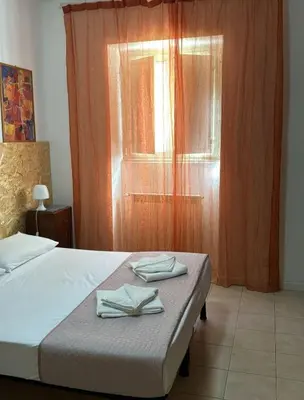 a bedroom with a bed with two towels on it at Fabio's Home Gemelli in Rome