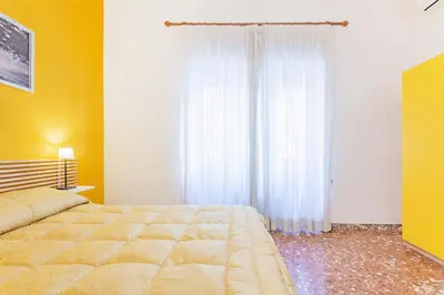 a bedroom with a large bed and a window at 10 Minutes by Car from St Peter's Basilica in Rome