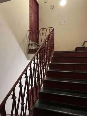 a set of stairs with a red door at EXCLUSIVE House OTTAVIANO in Rome