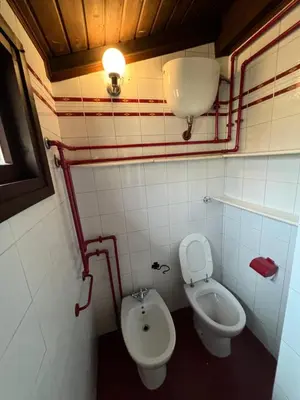a bathroom with a toilet and a bidet at EXCLUSIVE House OTTAVIANO in Rome