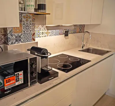 a kitchen with a microwave oven and a sink at Wood Apartment - Rome Battistini in Rome