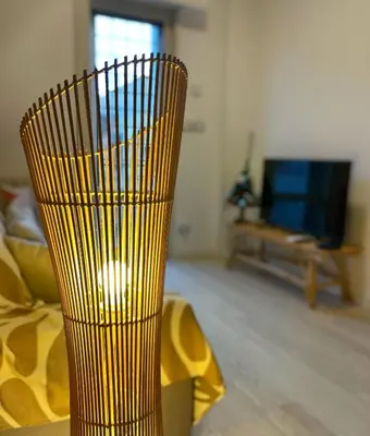 a yellow vase sitting on a table in a living room at Wood Apartment - Rome Battistini in Rome