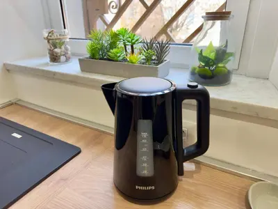 a black coffee pot sitting on a table next to a laptop at Trastevere alla Lungaretta, Rome in Rome