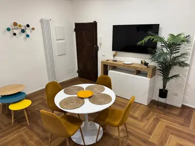 a dining room with a white table and chairs at Trastevere alla Lungaretta, Rome in Rome