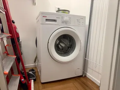 a white washing machine in a laundry room at Trastevere alla Lungaretta, Rome in Rome