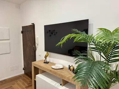 a wooden table in a room with a plant at Trastevere alla Lungaretta, Rome in Rome