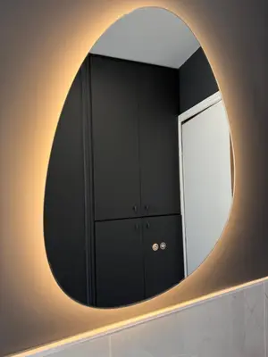 a circular mirror on a wall in a bathroom at Dolce Roma Apartment in Rome