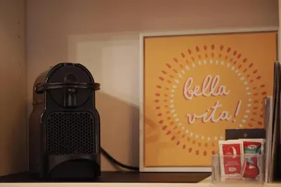 a black heater sitting on a counter next to a picture at Dolce Roma Apartment in Rome