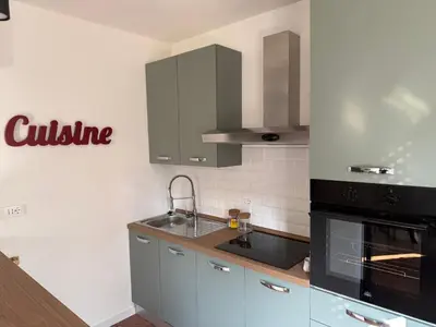a kitchen with a sink and a stove top oven at Dolce Roma Apartment in Rome