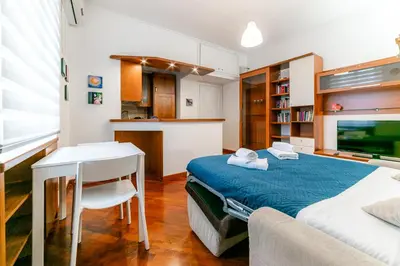a bedroom with a bed and a desk and a table at Daniele Flat - Ospedale Gemelli - Metro Battistini in Rome