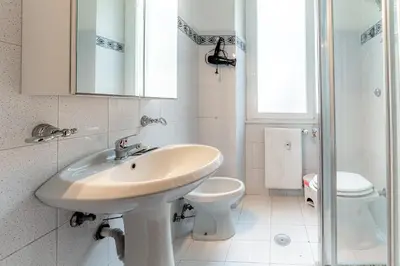 a white bathroom with a sink and a toilet at Daniele Flat - Ospedale Gemelli - Metro Battistini in Rome