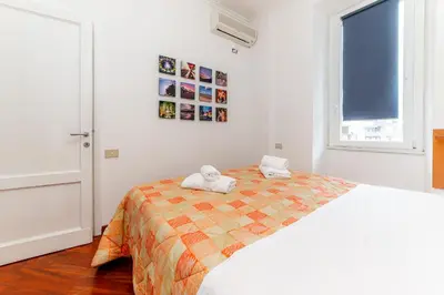 a white bedroom with a bed with towels on it at Daniele Flat - Ospedale Gemelli - Metro Battistini in Rome