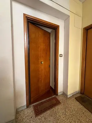 a wooden door in a room with a tile floor at Daniele Flat - Ospedale Gemelli - Metro Battistini in Rome