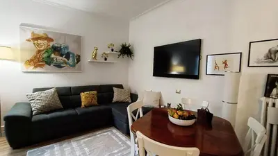 a living room with a couch and a table at Verdastro Apartment in Rome
