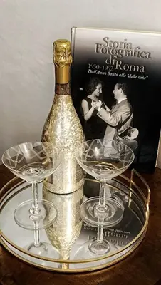 a group of glasses and a bottle on a table at Verdastro Apartment in Rome