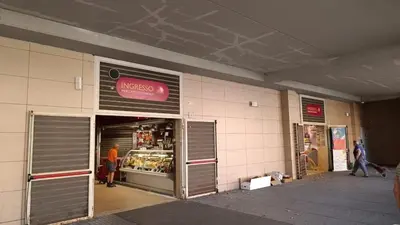 a store front of a store with people walking outside at Verdastro Apartment in Rome
