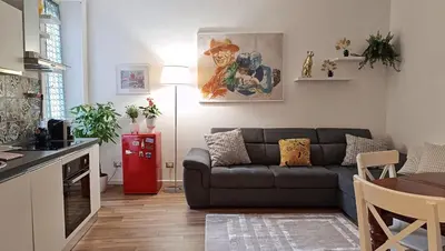 a small living room with a couch and a kitchen at Verdastro Apartment in Rome