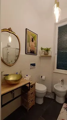 a bathroom with a sink and a toilet and a mirror at Verdastro Apartment in Rome