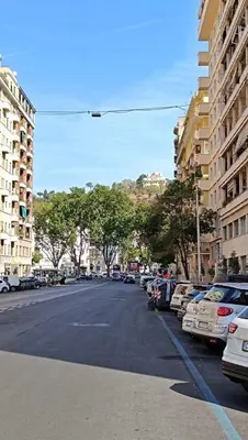 a city street with parked cars and buildings at Verdastro Apartment in Rome