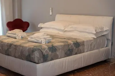 a white bed with towels on top of it at La casa di Gegè Appio Caffarella in Rome