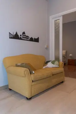 a brown couch in a living room at La casa di Gegè Appio Caffarella in Rome