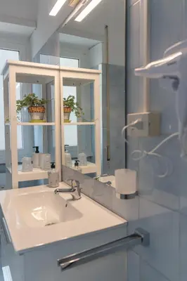 a bathroom with a sink and a mirror at La casa di Gegè Appio Caffarella in Rome