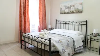 a white bedroom with a bed and a dresser at Casa Noemi in Rome