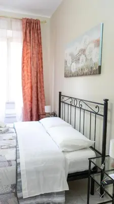 two beds in a room with towels on them at Casa Noemi in Rome