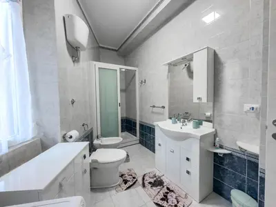 a bathroom with a toilet and a sink and a mirror at Casa Noemi in Rome