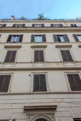 a building with a bunch of windows on it at 4 Cantoni, cosy apartment in Monti District in Rome