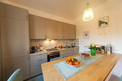 a kitchen with a table with a bowl of fruit on it at 4 Cantoni, cosy apartment in Monti District in Rome