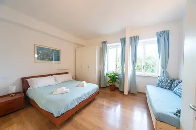 a small bedroom with a bed and a couch at 4 Cantoni, cosy apartment in Monti District in Rome