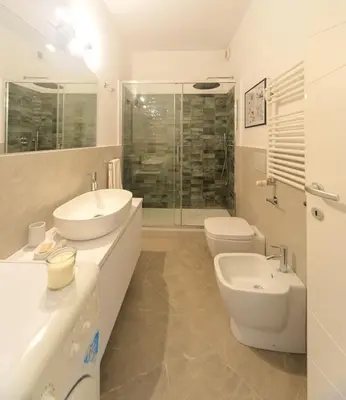 a bathroom with two sinks and a toilet and a shower at 4 Cantoni, cosy apartment in Monti District in Rome