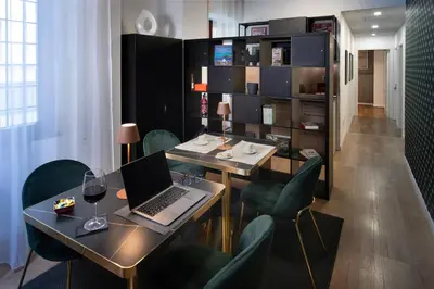 a room with a table with a laptop and chairs at Guest House VB Luxury Suites in Rome
