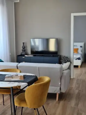 a living room with a couch and a table and chairs at Attico Vacanza Roma Nord - Casa Mengotti in Rome