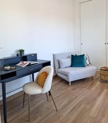 a room with a desk and a chair and a couch at Attico Vacanza Roma Nord - Casa Mengotti in Rome
