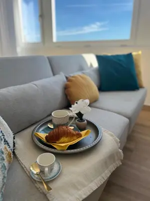 a table with a plate of food on a couch at Attico Vacanza Roma Nord - Casa Mengotti in Rome