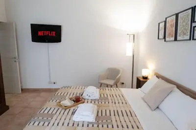 a hotel room with two beds and a sign that reads notify at Aunt's Vatican Home in Rome
