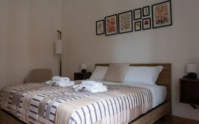 a bedroom with a bed with towels on it at Aunt's Vatican Home in Rome